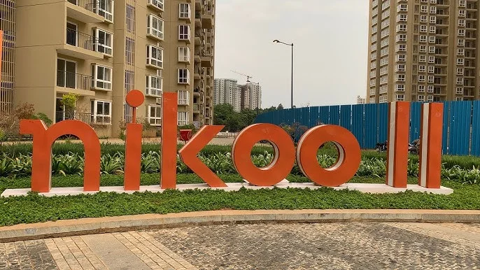 Completed residential towers of Nikoo Homes I and II showing the vibrant community living and established amenities in Bhartiya City.